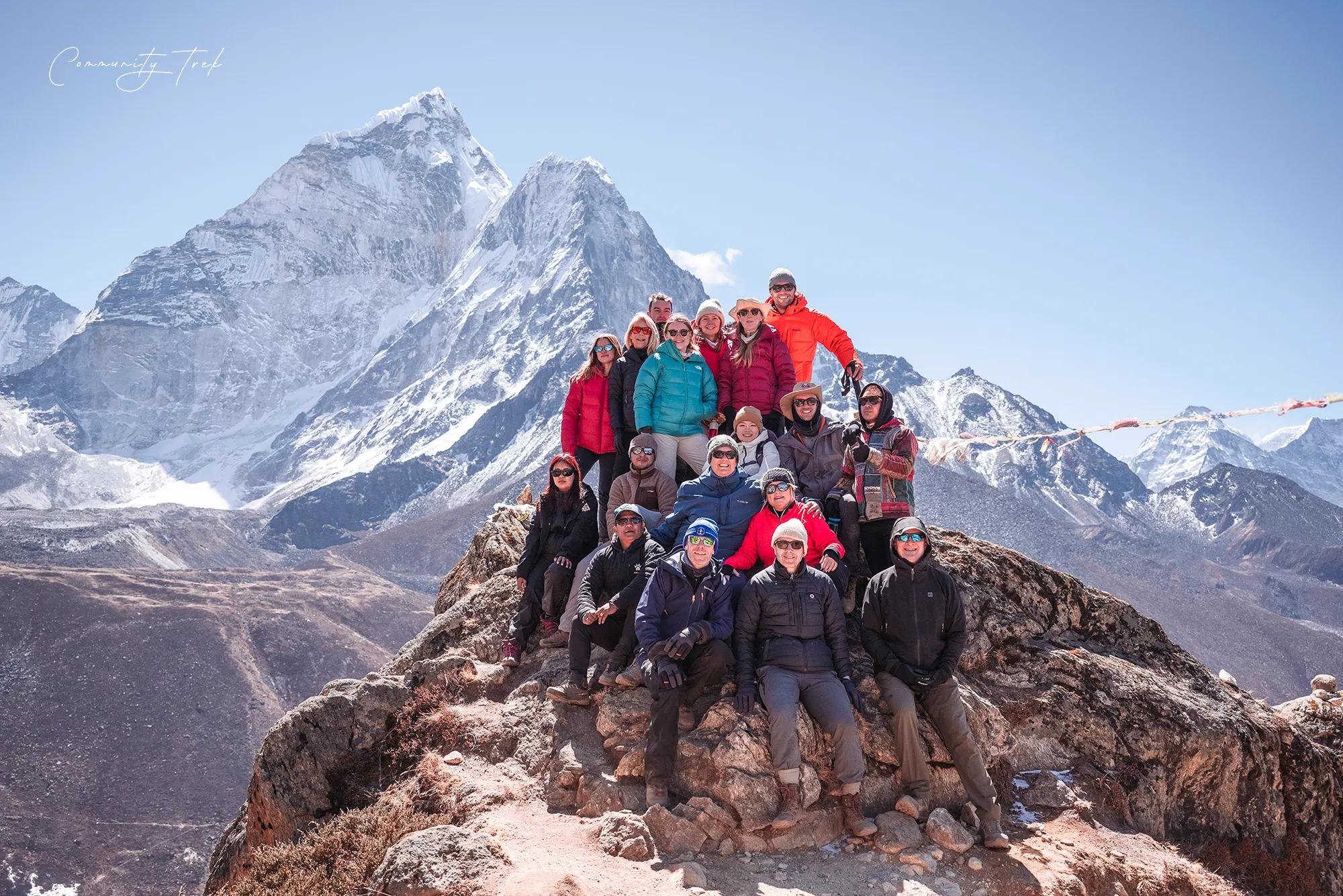 Trekkers enjoying views of Ama Dablam and surrounding Himalayan mountains