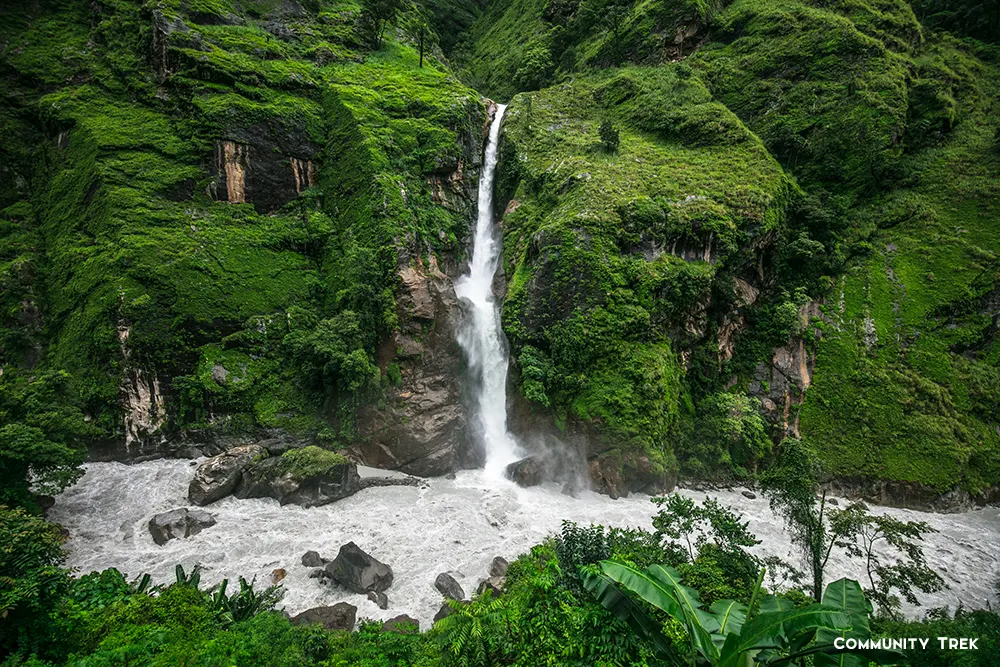 Waterfall cascading down rocky cliffs on the way to Manang Valley in Nepal