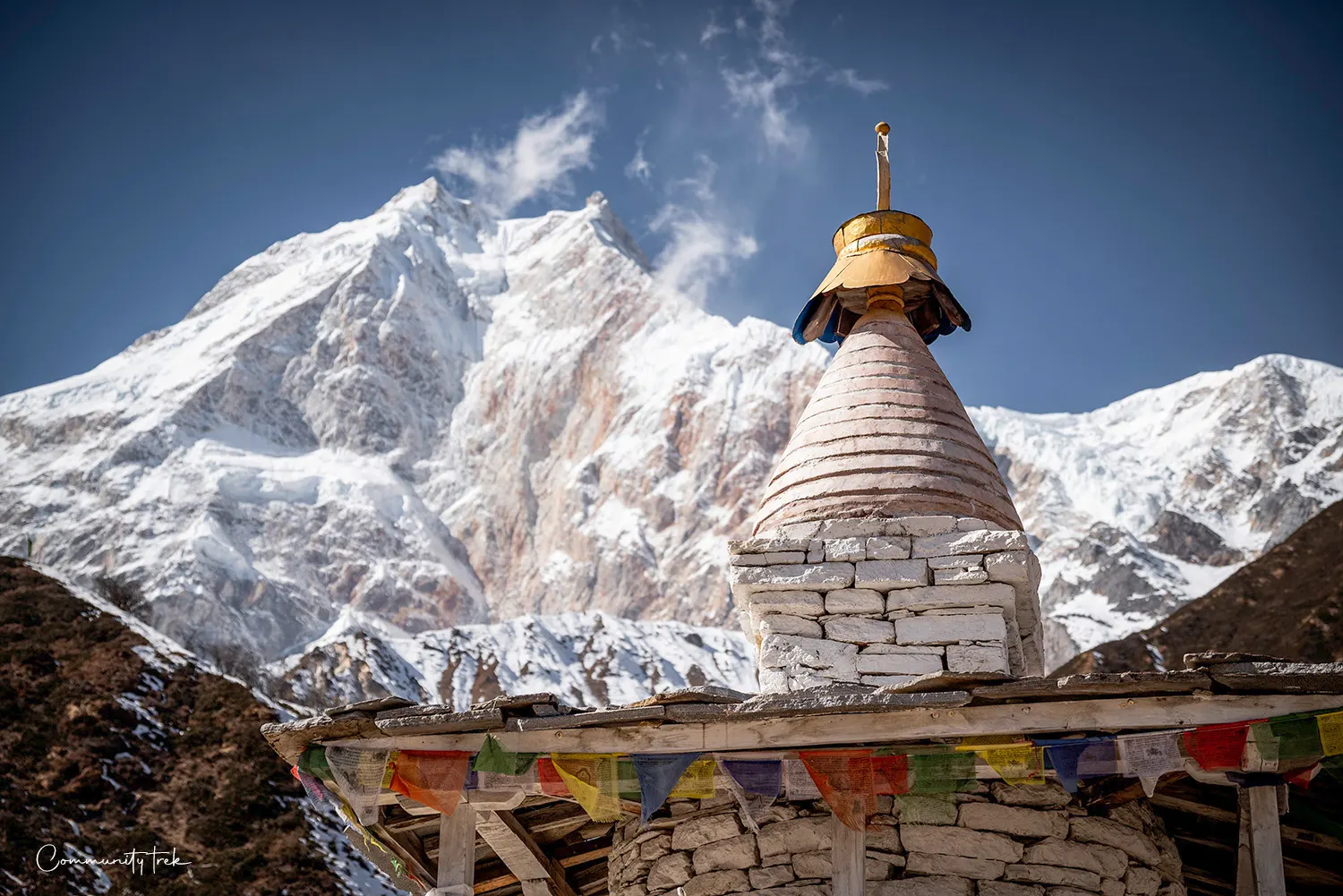 Stupa with Mount Manaslu and snow-covered Himalayan peaks in the background