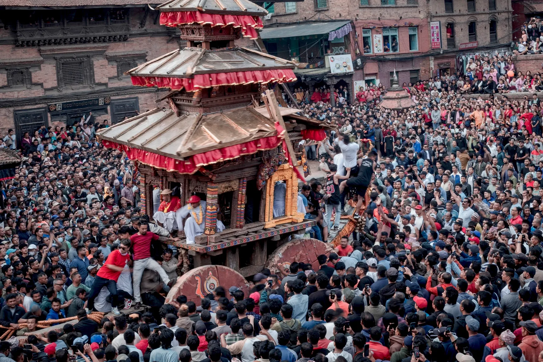 Cultural celebration of Bisket Jatra in Bhaktapur, Nepal, with traditional chariots, local people, and historic Newari architecture.